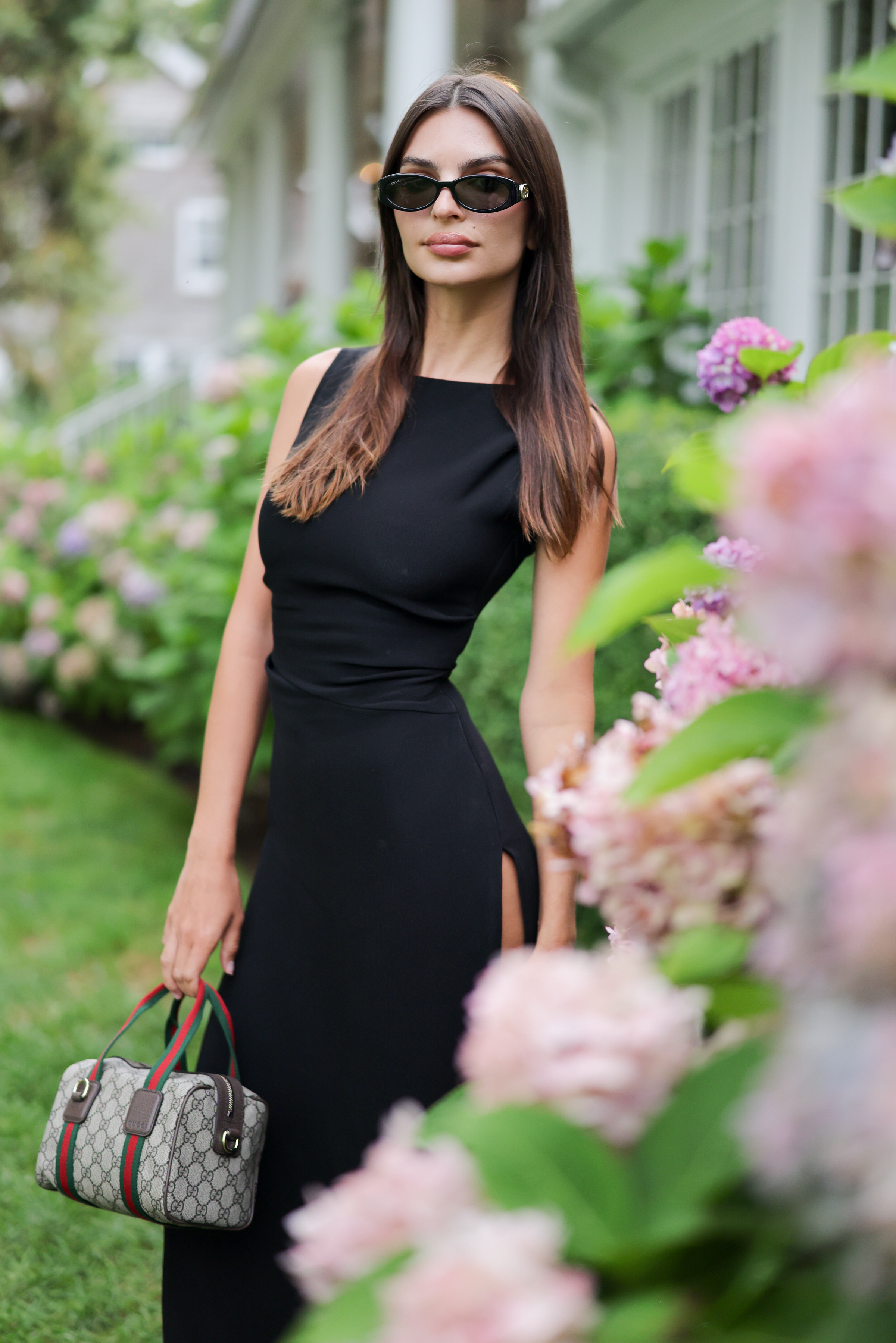 Emily Ratajkowski celebrates Gucci's GG monogram campaign in a little black dress with two Gucci Double-G bags