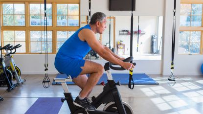 older man in spin class