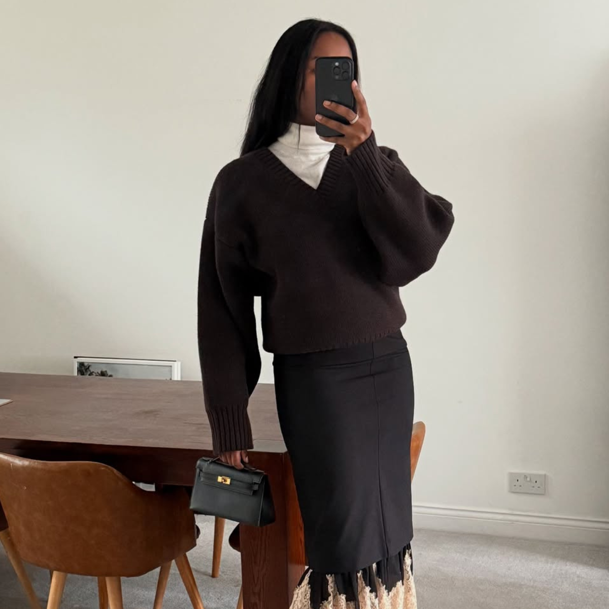 @nlmarilyn wears black jumper black skirt