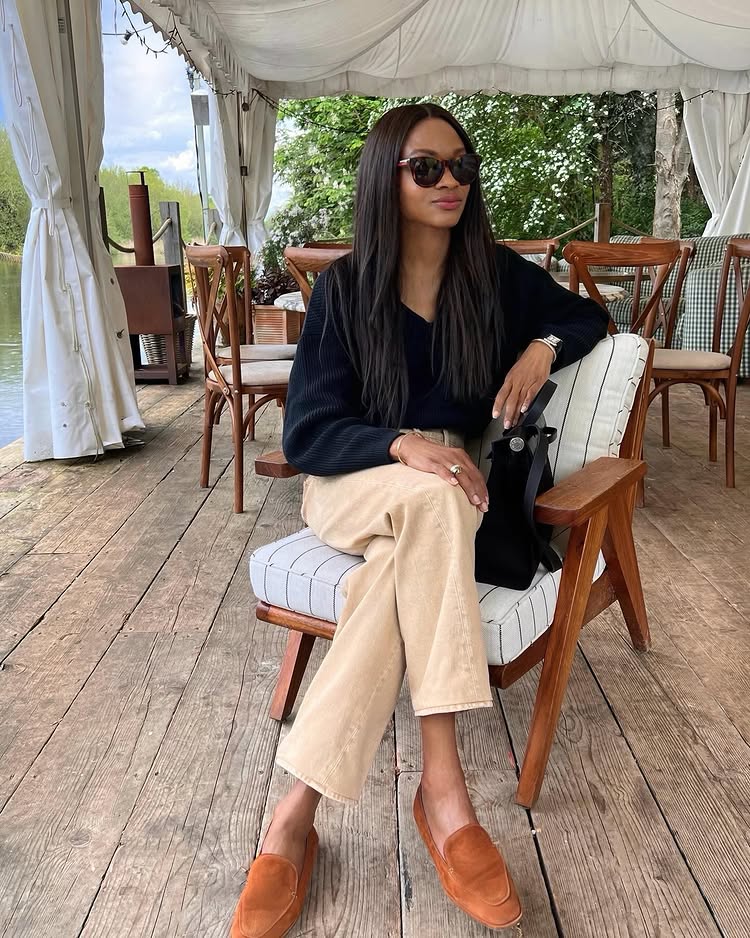 @symphonyofsilk wears a black blouse, beige trousers and tan suede loafers