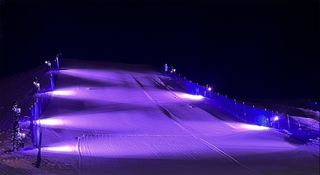 A ski slope alit in purple lights with lighting solutions from GLP.
