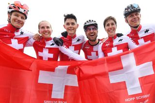 Nino Schurter celebrates with his Swiss teammates after winning the Mixed Team Relay event