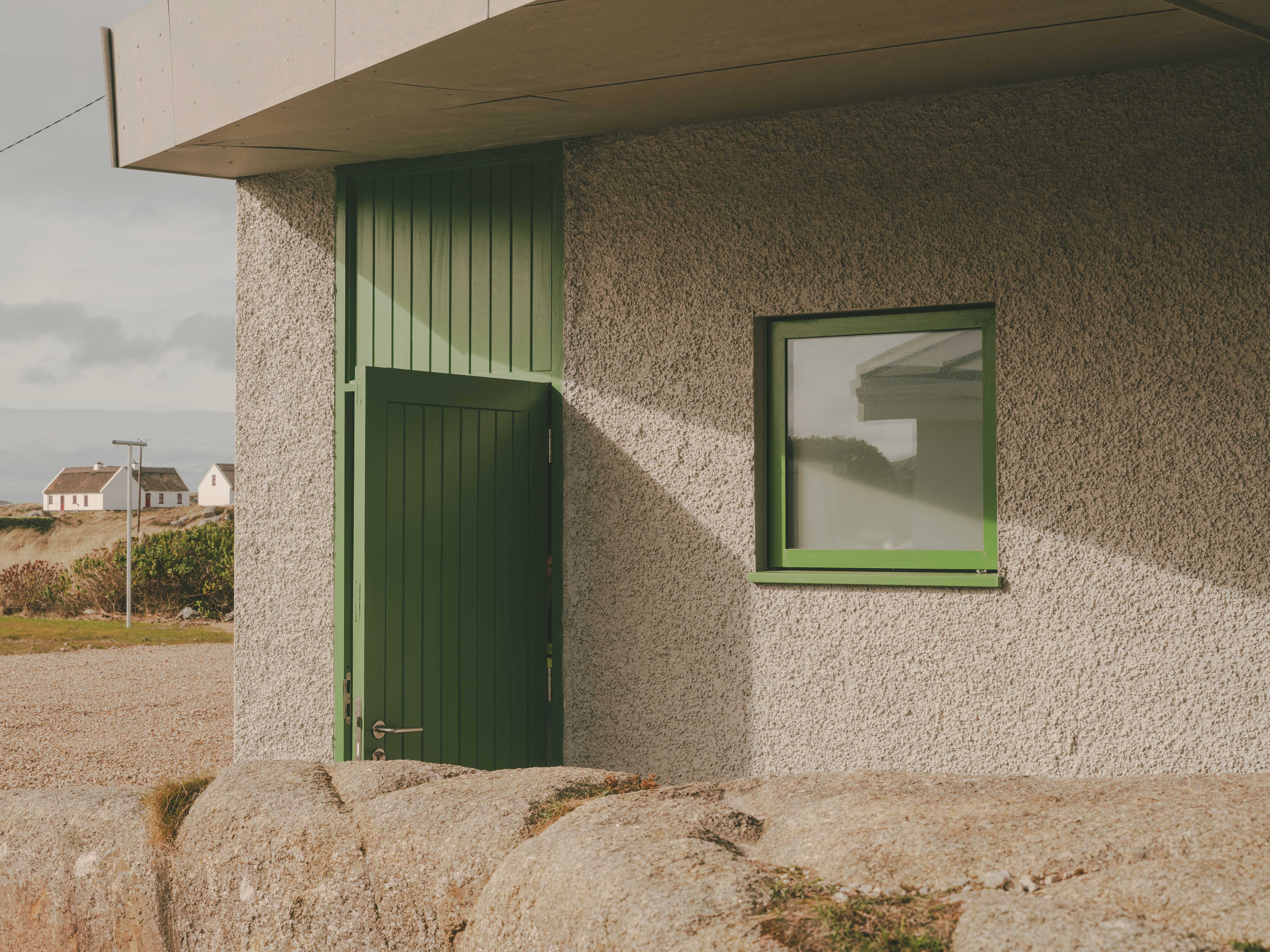Green exterior detailing references the local vegetation