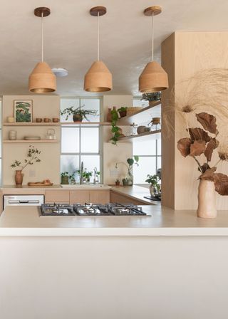 A neutral kitchen with pendant lights above the island