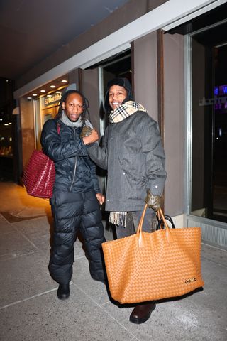 A photo of A$AP Rocky carrying a customized orange leather Intrecciato bag from Bottega Veneta.