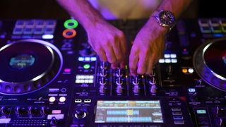 Hands on a DJ mixer