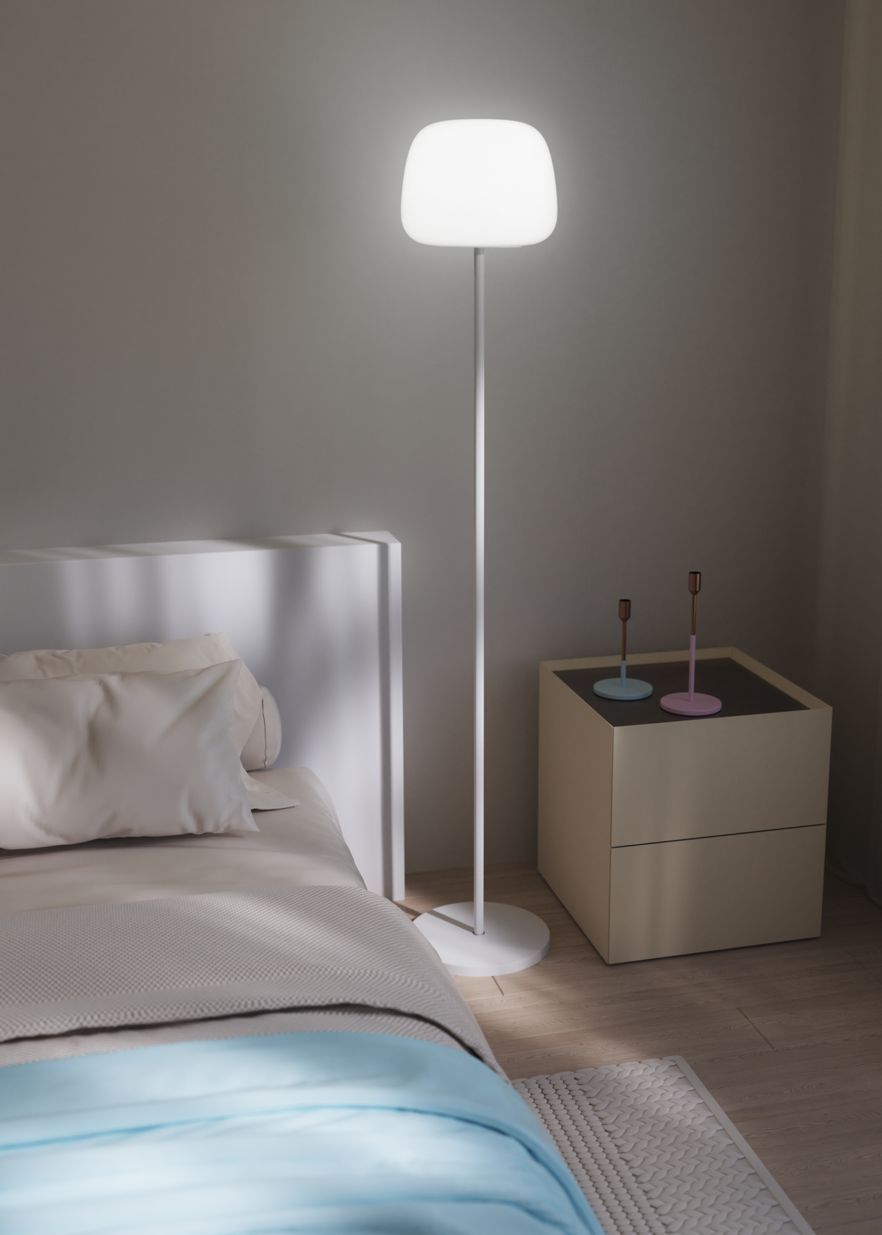 A white floor lamp in a bedroom