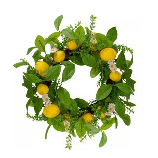 A green leafy circular wreath with yellow lemons and white and lemon daisies dotted around it