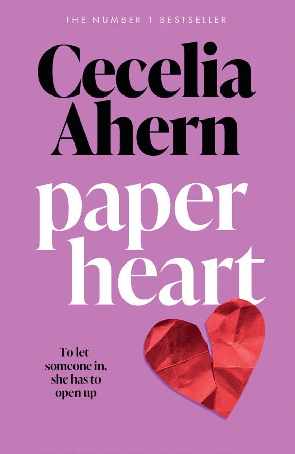 Cover of &#039;Paper Heart&#039; by Cecelia Ahern, featuring a vibrant purple background with bold black and white text and a red heart made of paper.
