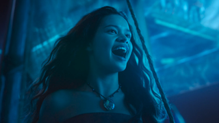 Catherine Lagaʻaia as Moana singing with blue light on her 