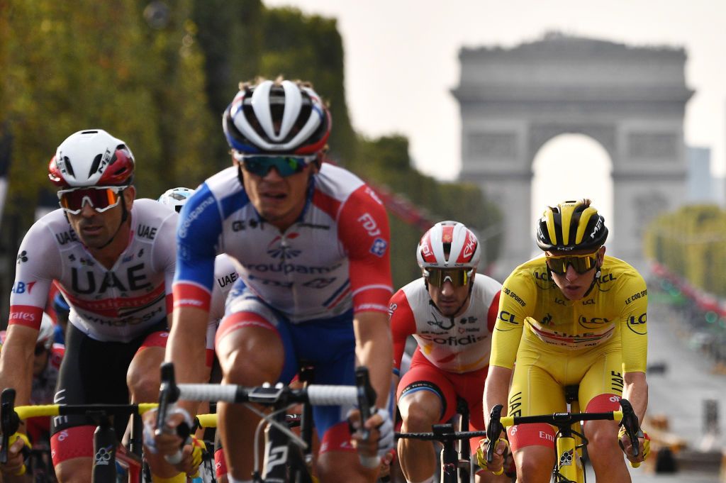 Team UAE Emirates rider Slovenias Tadej Pogacar wearing the overall leaders yellow jersey 1stR rides on the Champs Elysees avenue with the Arc de Triomphe in the background during the 21st and last stage of the 107th edition of the Tour de France cycling race 122 km between ManteslaJolie and Champs Elysees Paris on September 20 2020 Photo by AnneChristine POUJOULAT AFP Photo by ANNECHRISTINE POUJOULATAFP via Getty Images