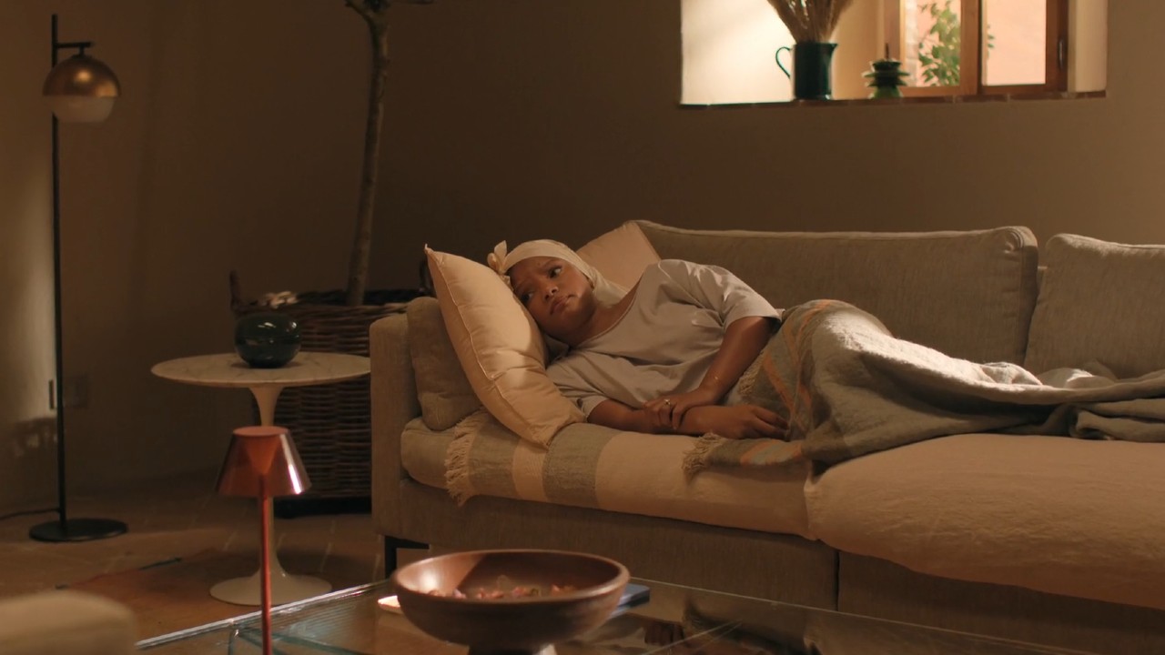 Halle Bailey lying on the bed in You, Me, and Tuscany.