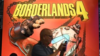 Gamers stand in front of a Borderlands 4 video game placard from Gearbox Software during the Gamescom video games trade fair at the Trade Fair Center in Cologne, western Germany, on the first day of the fair on August 20, 2025.
