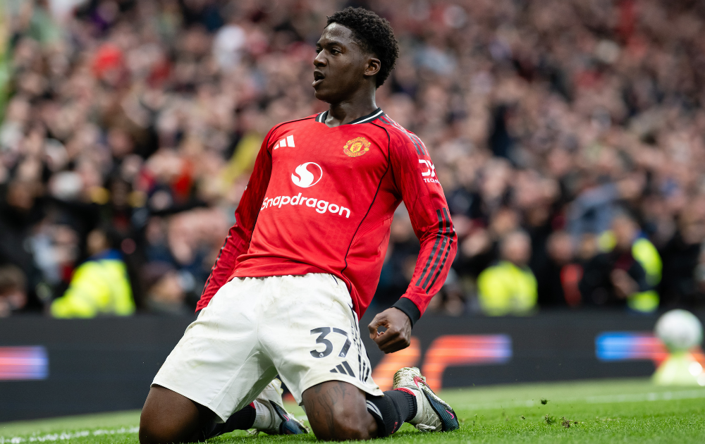 Kobbie Mainoo of Manchester United celebrates scoring a goal to make the score 3-2 during the Premier League match between Manchester United and Liverpool at Old Trafford on May 3, 2026 in Manchester