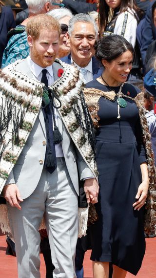 Prince Harry and Meghan Markle being greeted in traditional New Zealand fashion