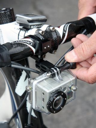 Dean Dealy of GoPro was busy fitting a number of team bikes with custom mounts for the company's tiny video cameras, such as this one that hangs below an SRM computer.