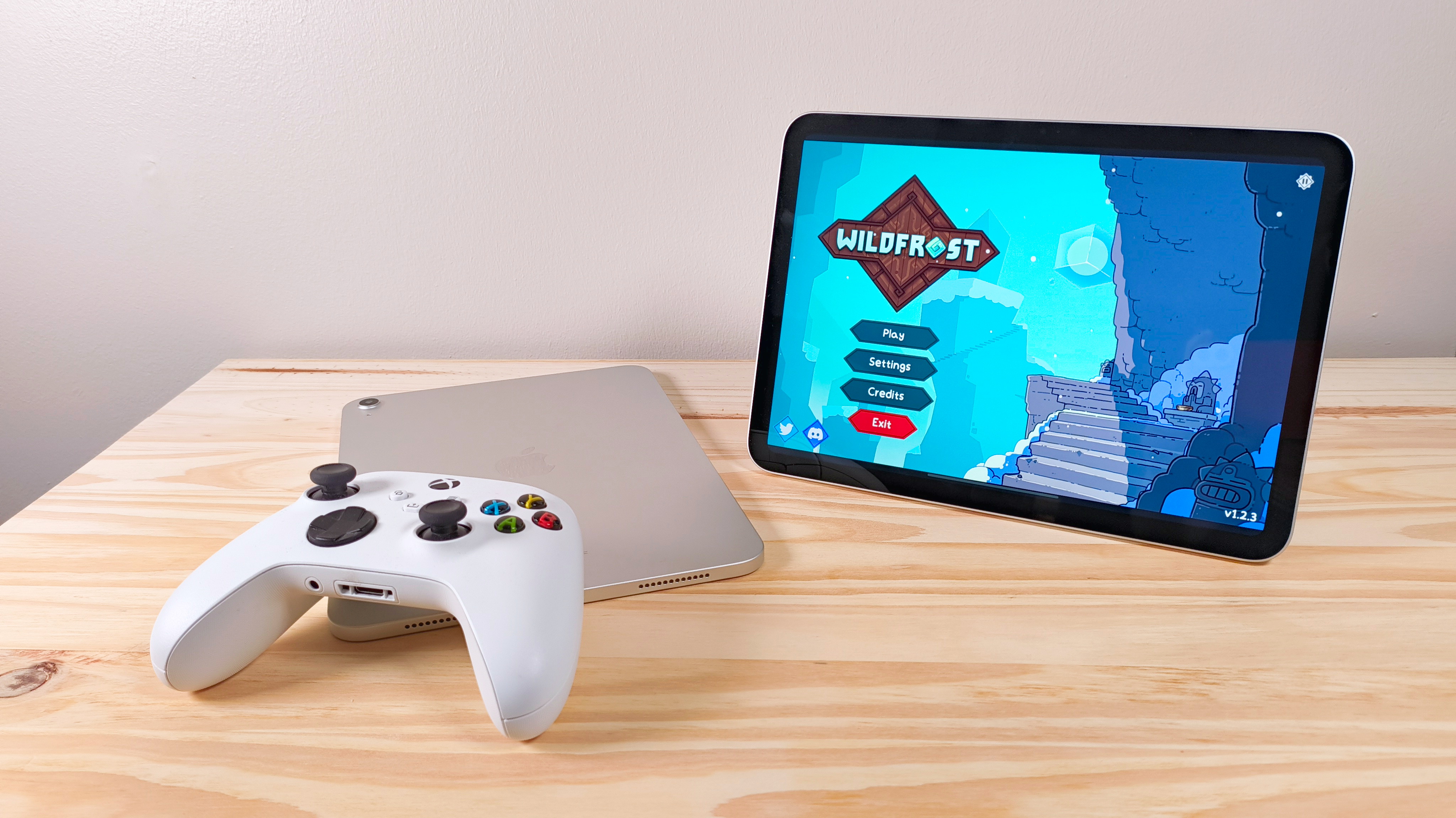 The iPad 11 running Wildfrost next to a face-down iPad 10 and an Xbox controller