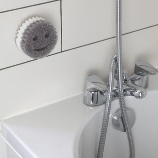 grey scrub with white tiles and tap
