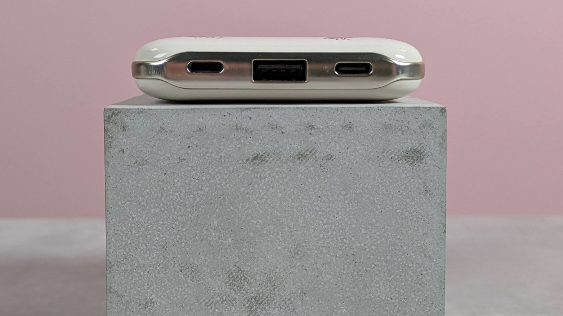 Close-up of ports on VQ Cath Kidston 5,000mAh Power Bank, on plinth with pink background