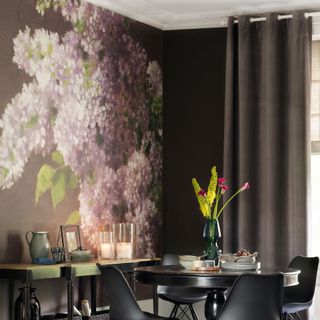 A purple dining room with a floral wall mural