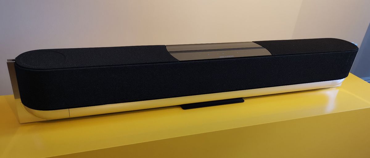 The Bang &amp; Olufsen Beosound Theatre Dolby Atmos soundbar.jpg in black on a yellow surface