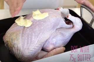 Person dotting the turkey with butter illustrating How to cook a turkey