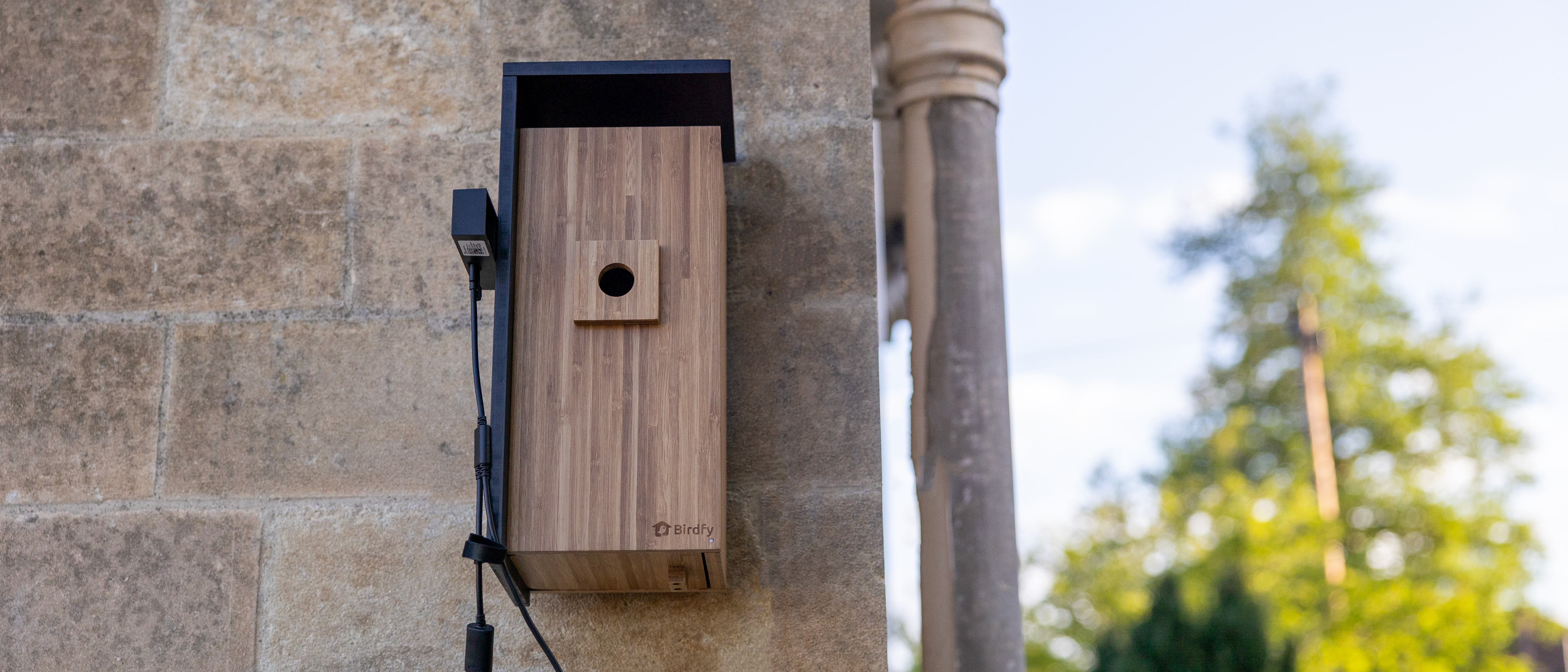 The Birdfy Nest Duo mounted on a Bath stone wall
