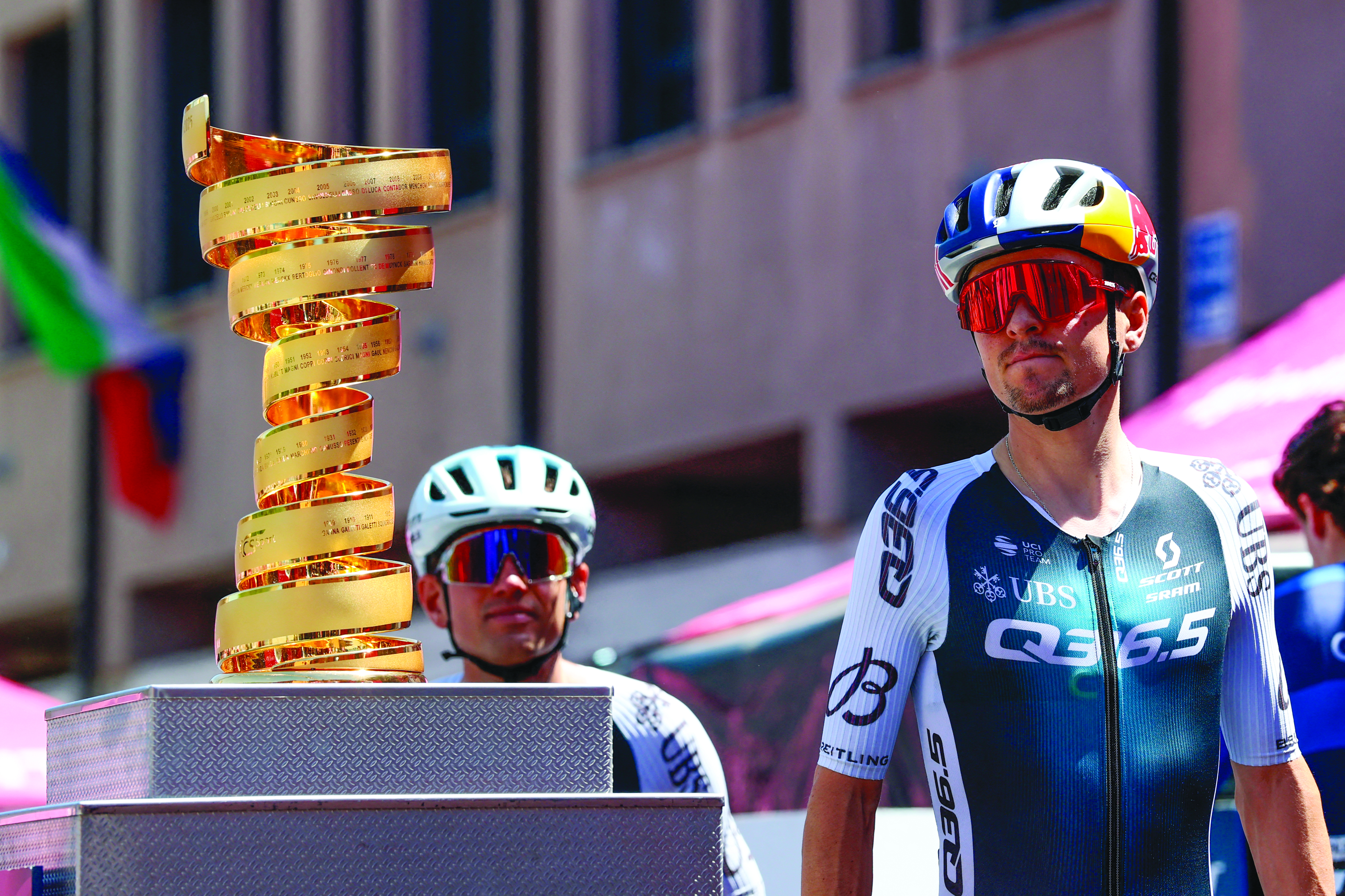 Tom Pidcock next to a trophy