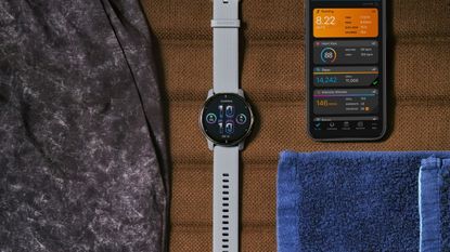 an image of a watch next to a phone with the garmin app open