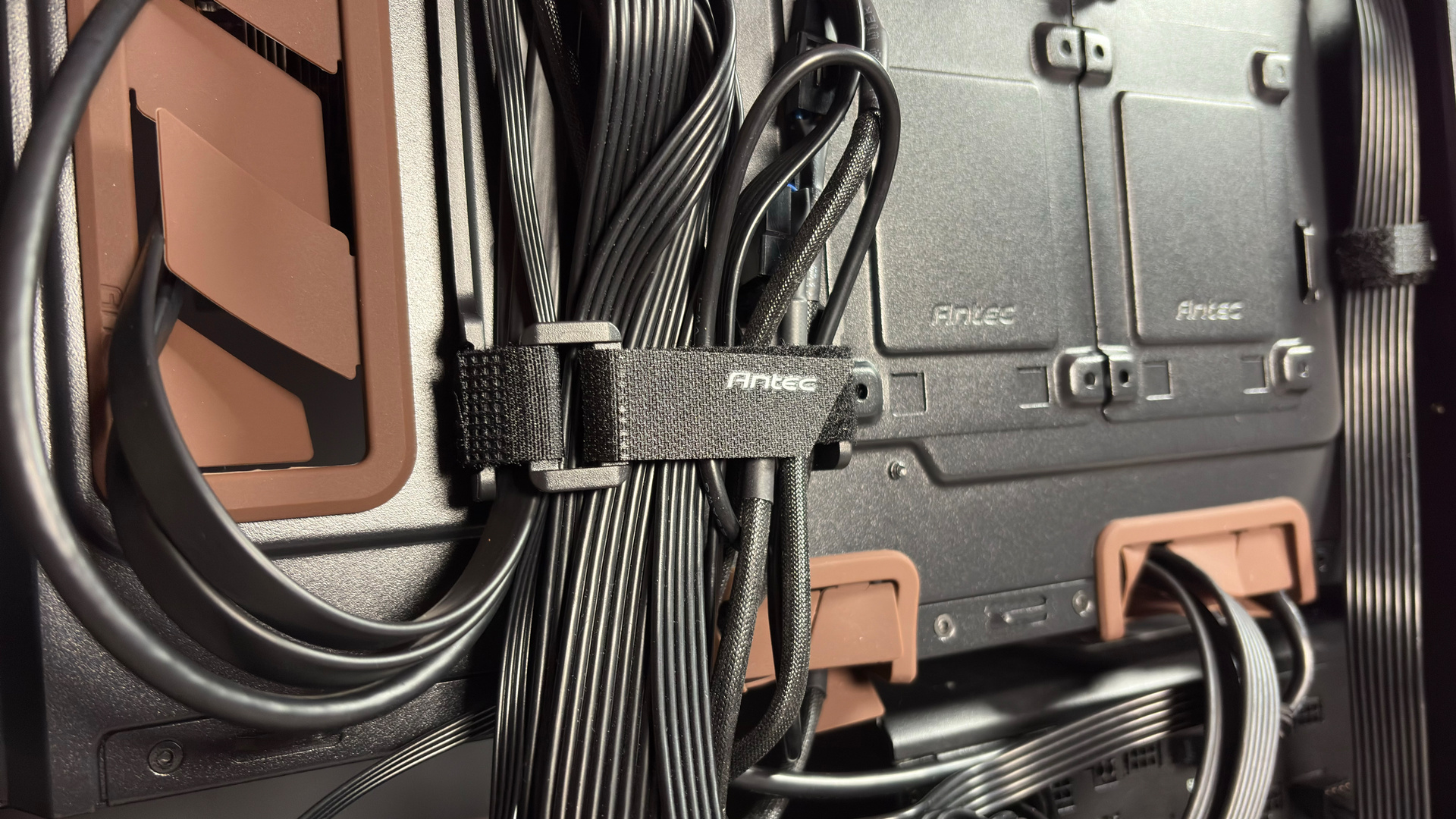 The Antec Flux Pro Noctua Edition on a desk with various parts disassembled.