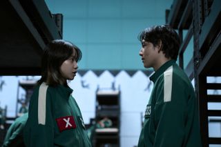 two squid game players look at each other in the bunks in a still from season 2