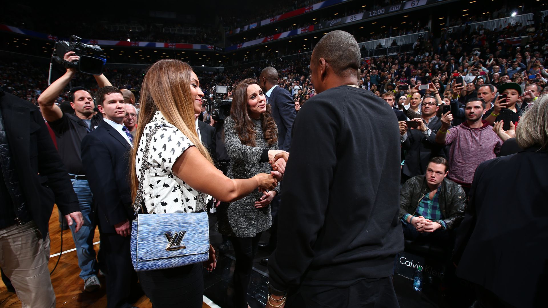 Kate Middleton shaking hands with Jay Z, with Beyonce to the side