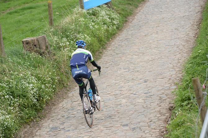 An Orica-GreenEdge rider tests out the cobbles