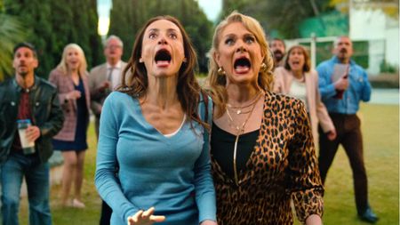 An image from Welcome to the Family showing to women screaming