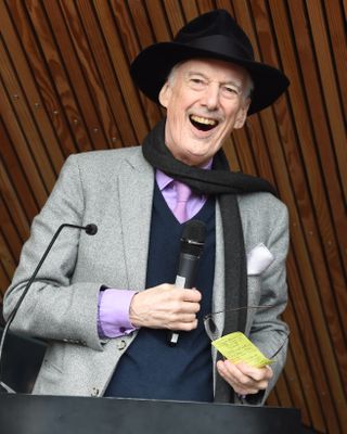 Charles Jencks laughing with a microphone in his hand