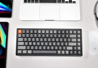 The Keychron K2 V2 non hot swappable version on a desk surrounding by computing equipment