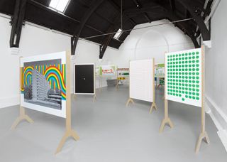 Artworks featuring a black and white building with multicoloured retro background, and a piece with green spots