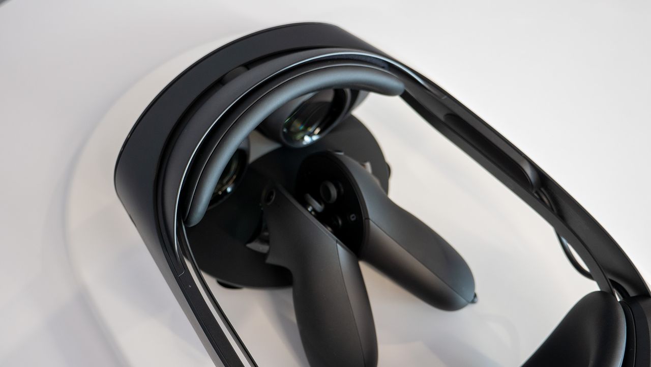 Meta Quest Pro headset with Quest Touch Pro controllers charging on the included dock