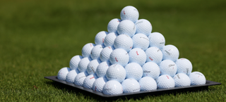 Golf balls in a pyramid on a driving range
