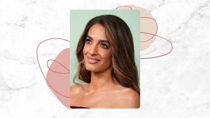 Amal Clooney is pictured with her long, wavy hair pushed behind her shoulders and wearing a red velvet strapless dress at the "Jay Kelly" premiere during the 63rd New York Film Festival at Alice Tully Hall on September 29, 2025 in New York, New York/ in a white and grey marble-look template with pink dots and swirly lines