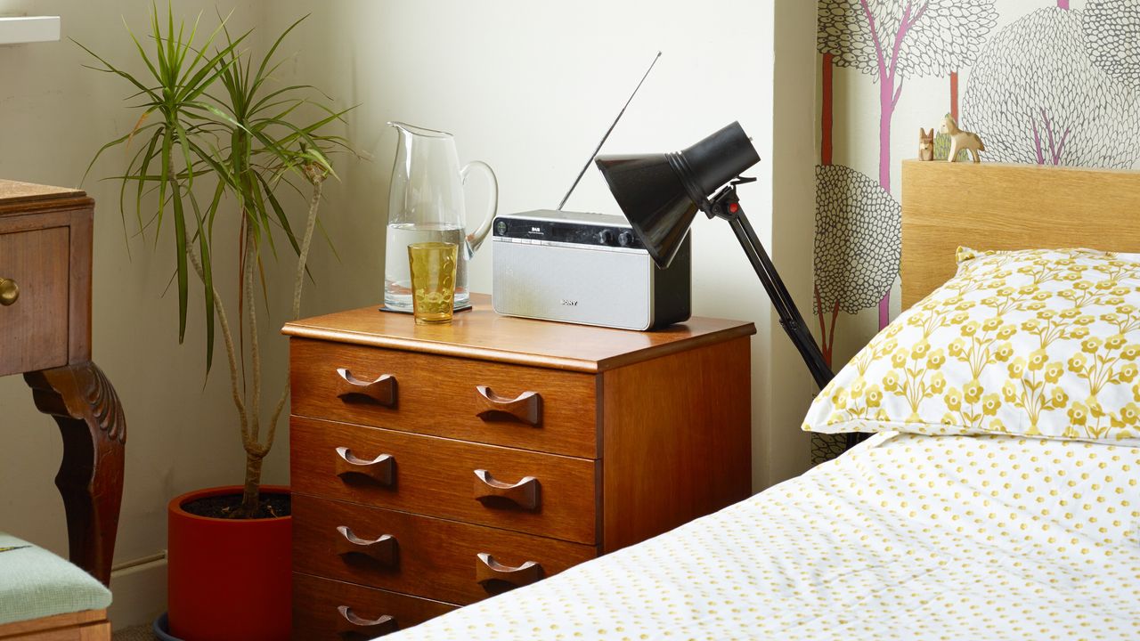 A bedroom with a mid-century bedside cabinet