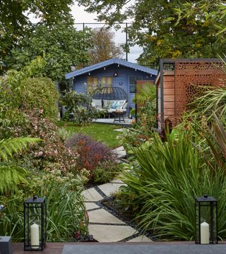 modern garden with zig zag path and grey shed
