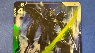 A Gundam on a card staring into the foreground, with numbers and text on the edges