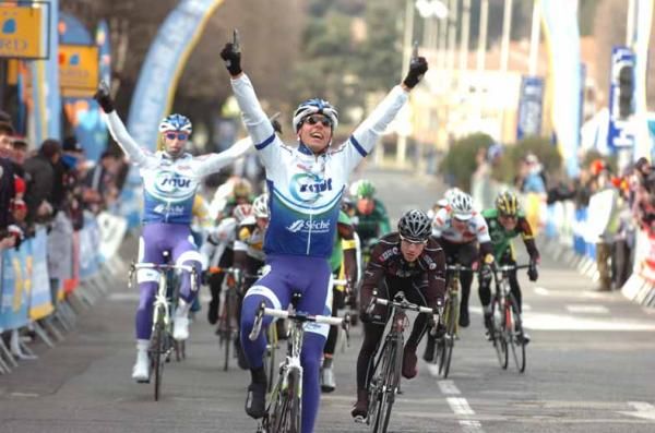 Stephane Poulhies (Saur - Sojasun) wins with his teammate Jimmy Engoulvent celebrating in the background.