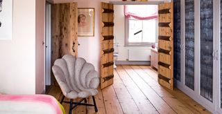 Pink bedroom with grey built-in wardrobes leading to an ensuite bathroom