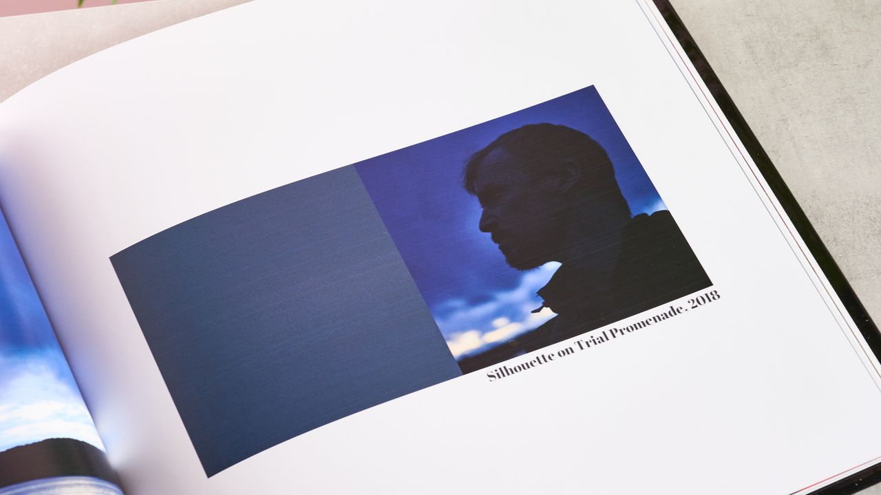 Blue square alongside man looking to the sky in Printerpix photo book
