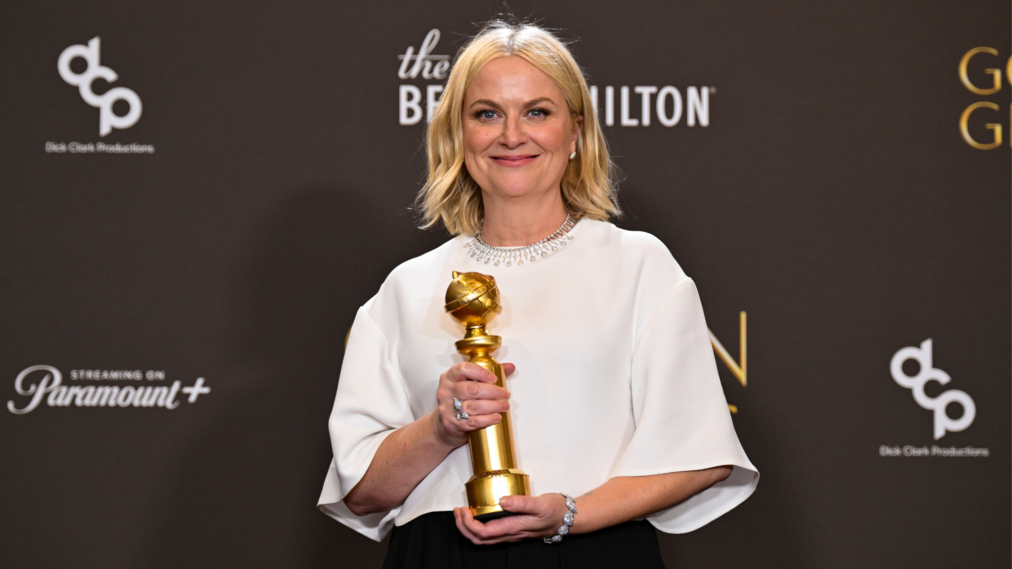 Amy Poehler with her award for best podcast at the 83rd Golden Globes 