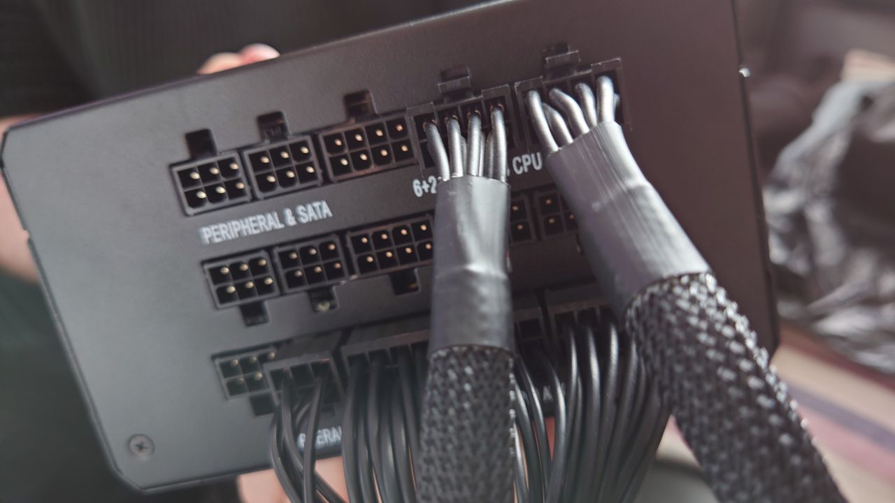 Plugging in the necessary cables into our 1000W PSU