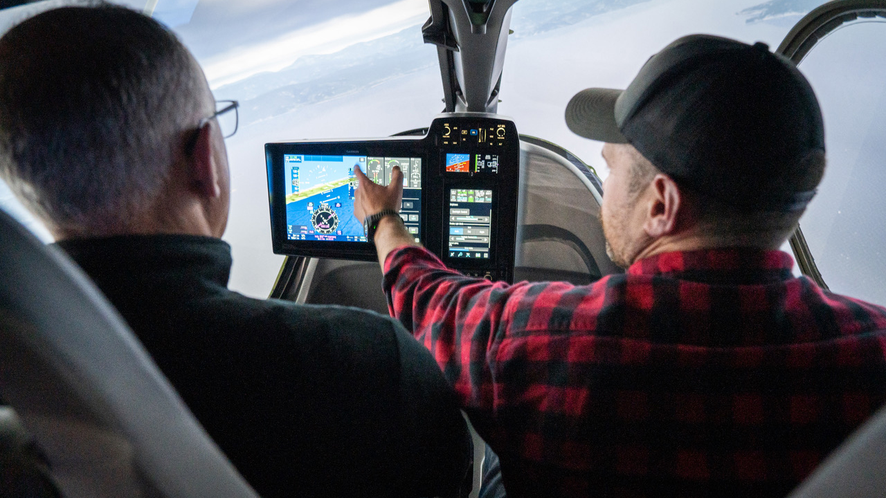 Flight simulators brought to life with technology as two pilots simulate flight in a fake cockpit.