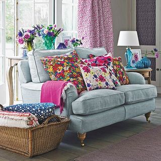 lining room with posh pad and grey sofa with floral cushions